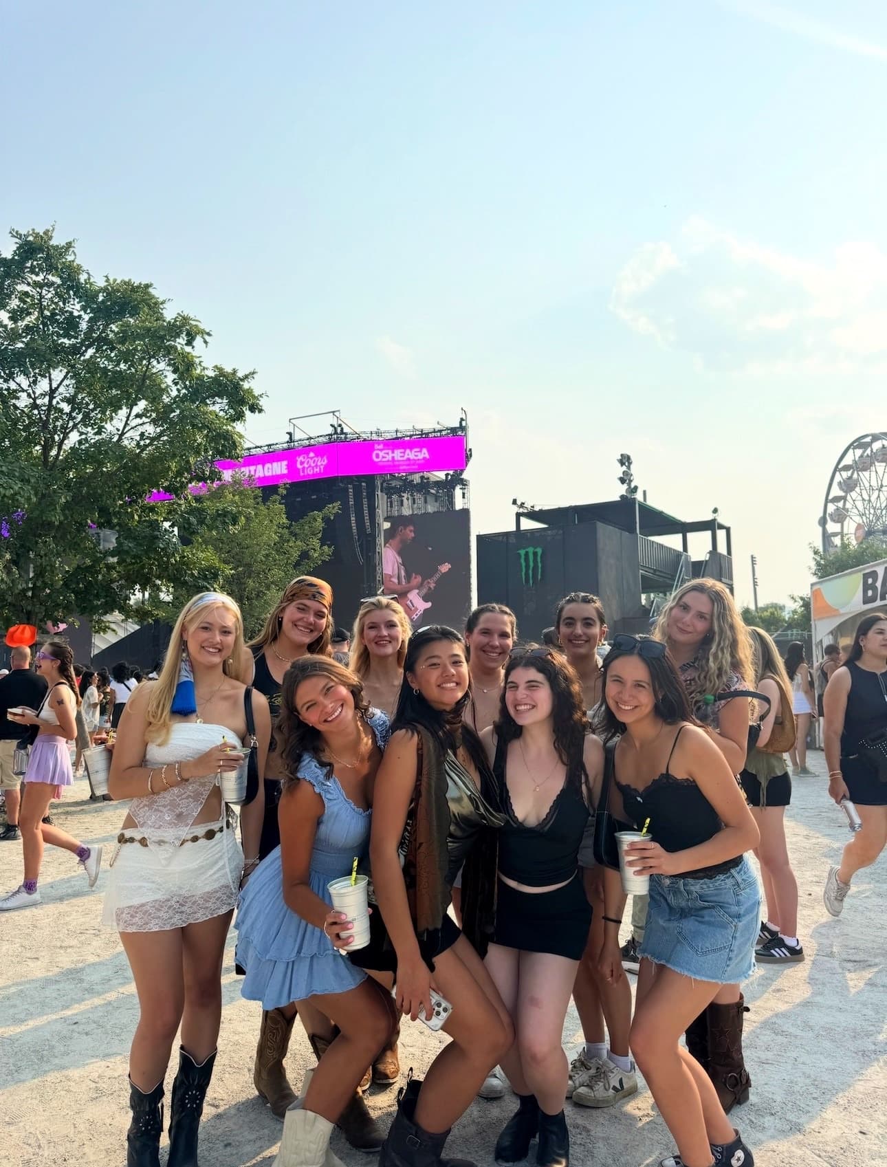 Sisters posing together at the Osheaga music festival grounds in Montreal