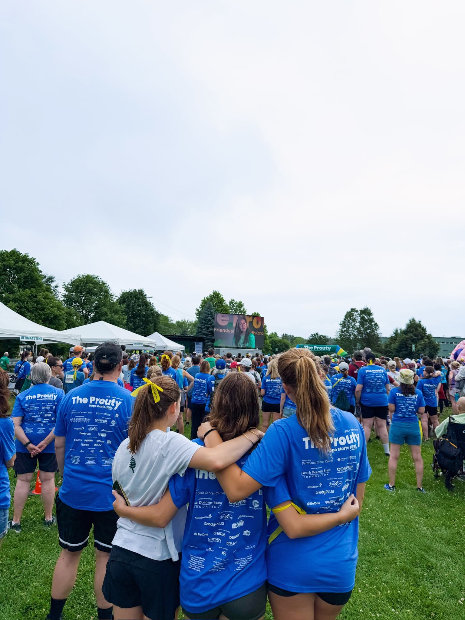 Sisters arm in arm in the crowd at the Prouty