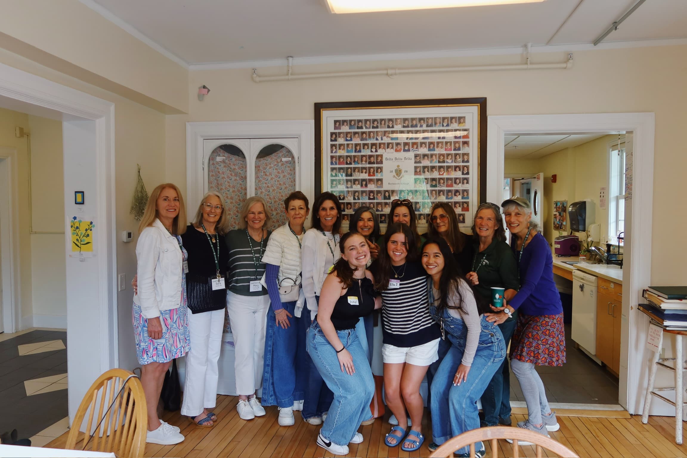 Alumnae and current sisters together beneath the 1986 Delta Delta Delta composite