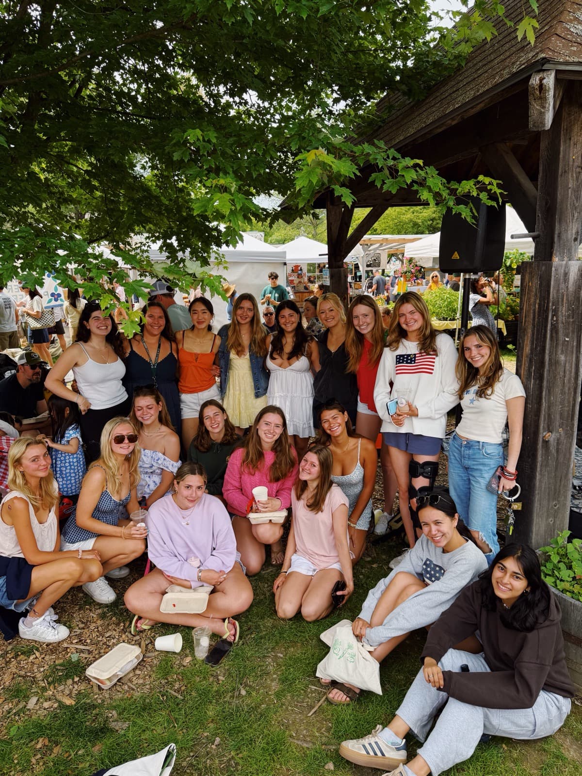 Sisters at the summer farmers market, under a tree