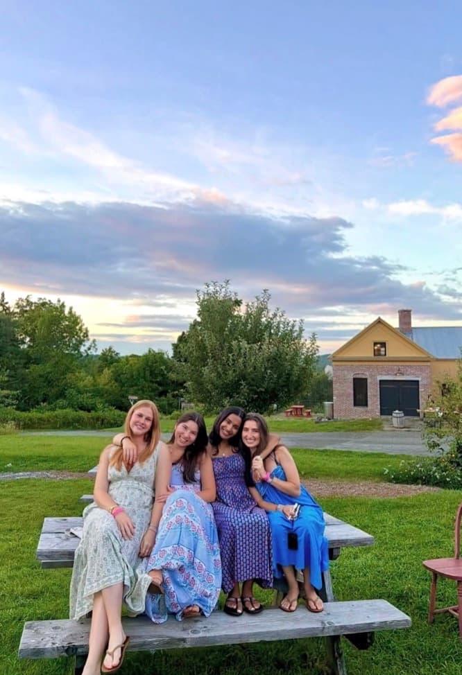 Four sisters on a picnic table at sunset