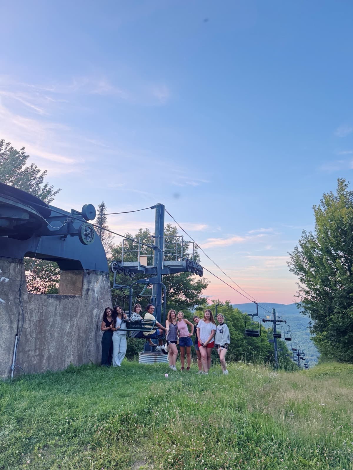 Sisters at a ski lift at sunset